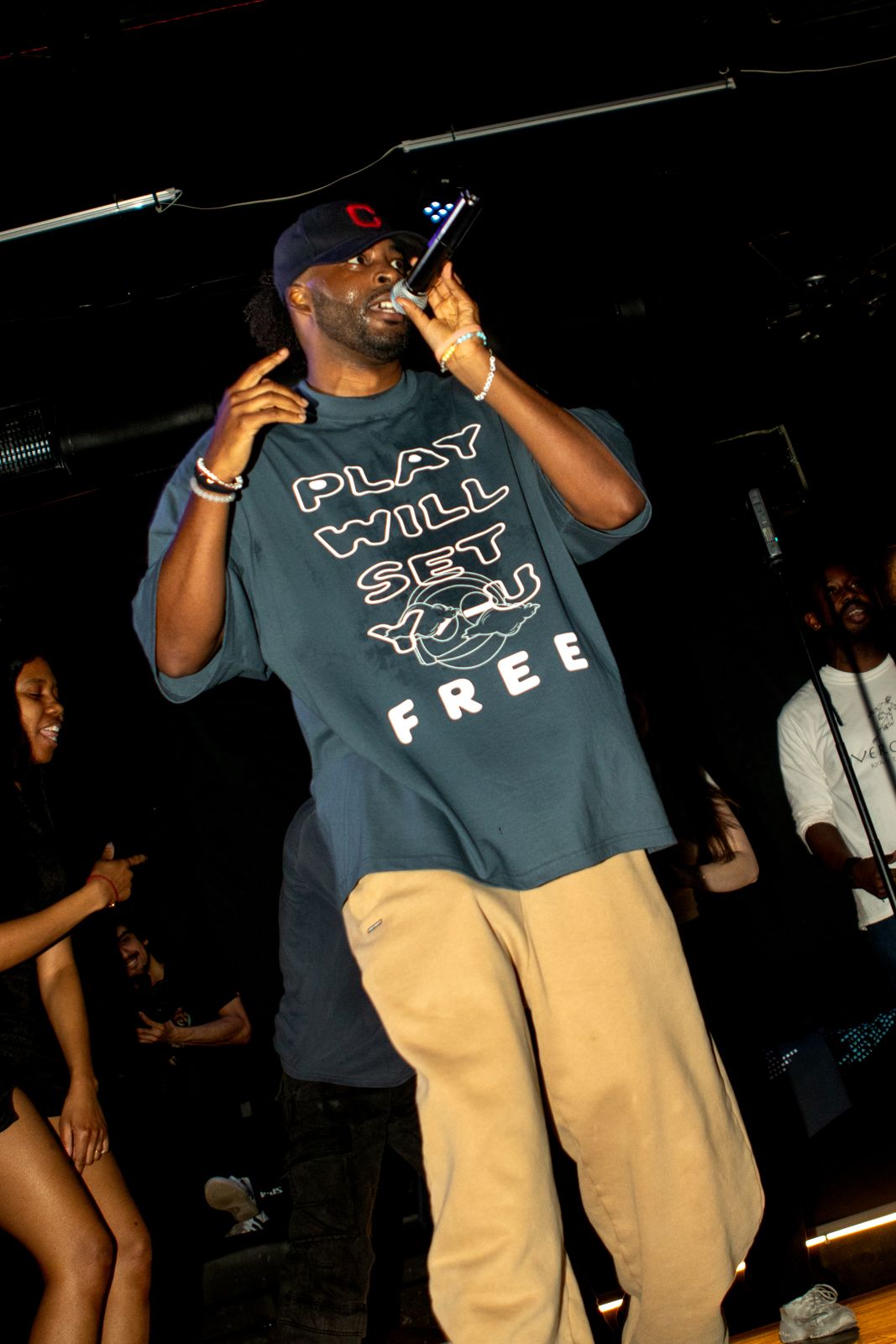 Ryan performing in a Play Will Set You Free tee, crowd behind him