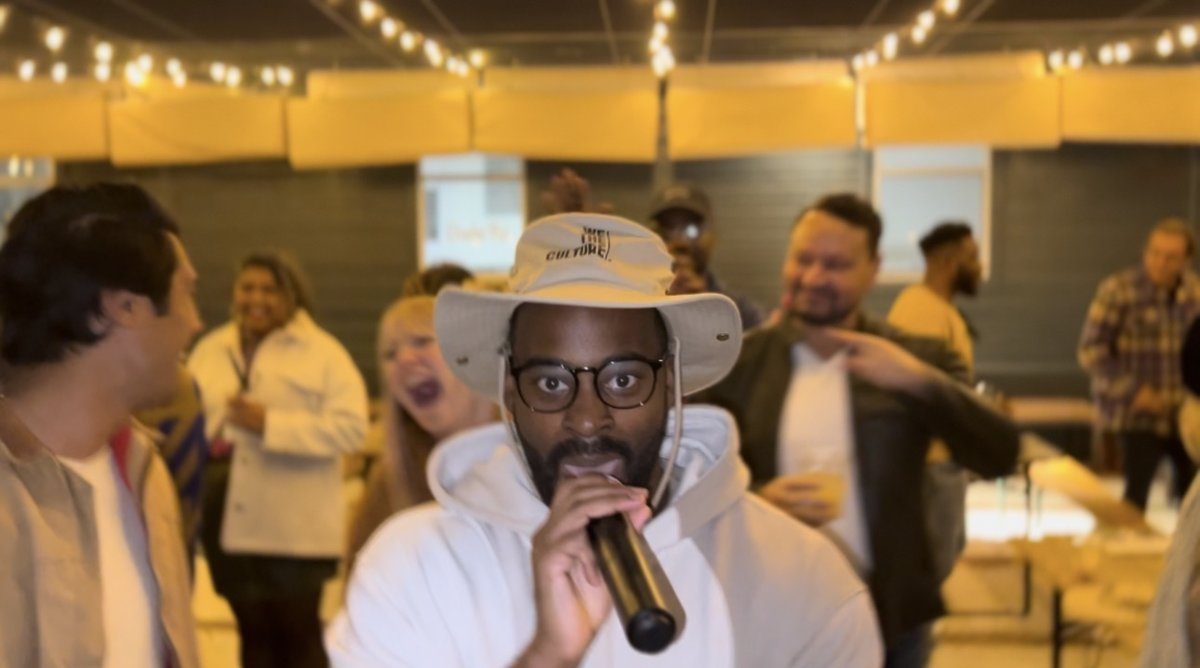 Ryan performing in a We The Culture hat