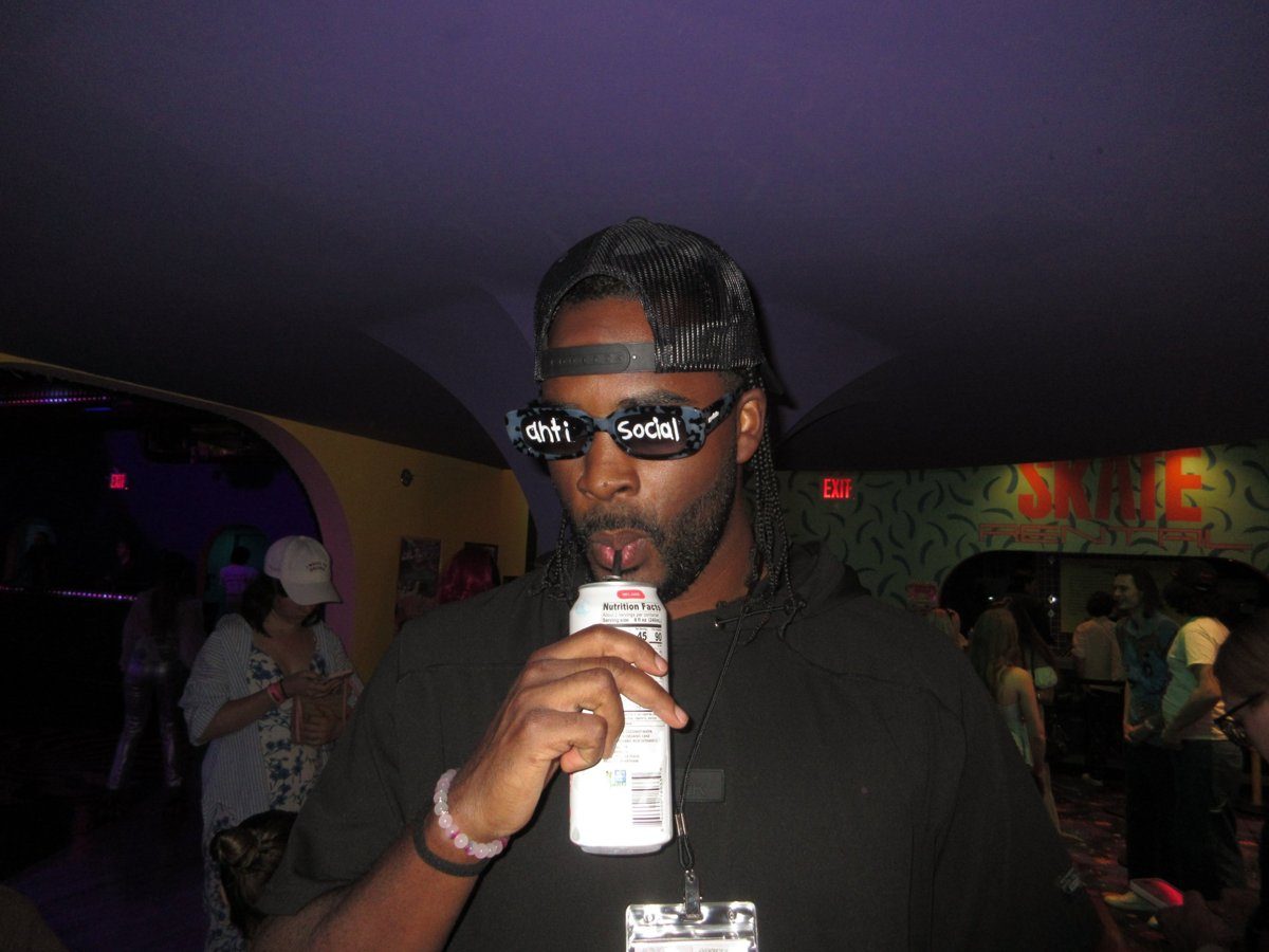 Ryan in Anti Social sunglasses at a roller rink event