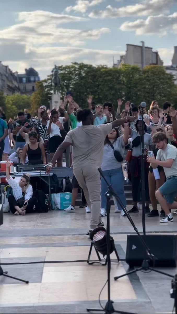 Ryan performing for a crowd with hands in the air